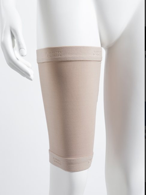 Manchon compressif de cuisse, coloris chair, sur une jambe de mannequin.
